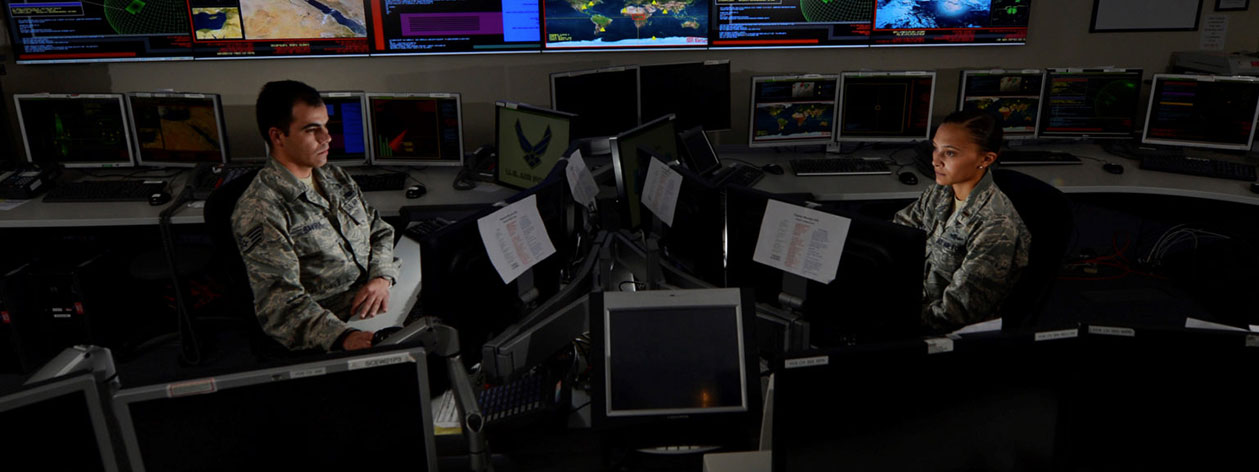 Two U.S. Air Force personnel in a computer room
