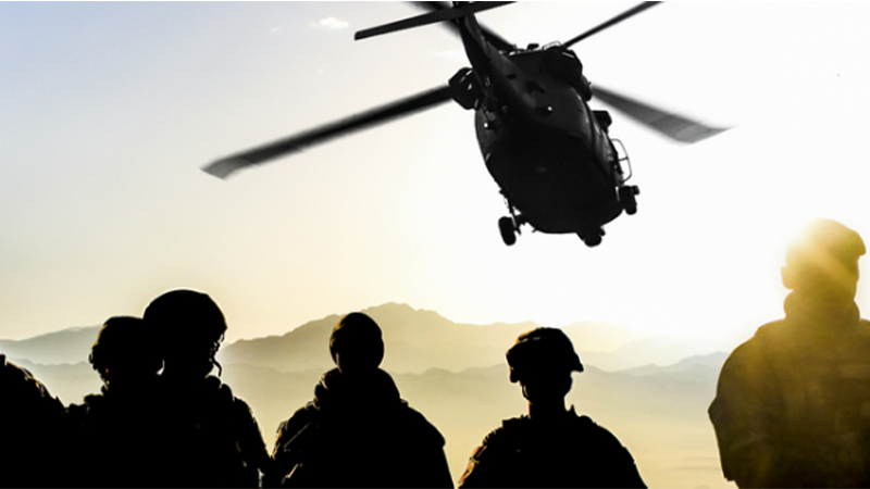 Silhouettes of soldiers during a military mission at sunset