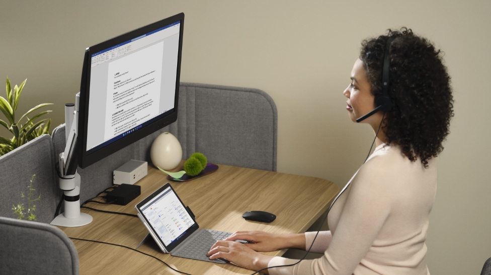 woman works on a document at her office desk