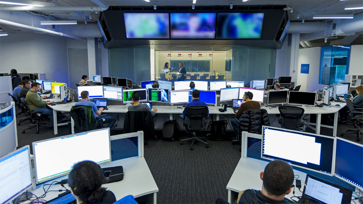 Overhead view of a control center with multiple support stations and tv monitors