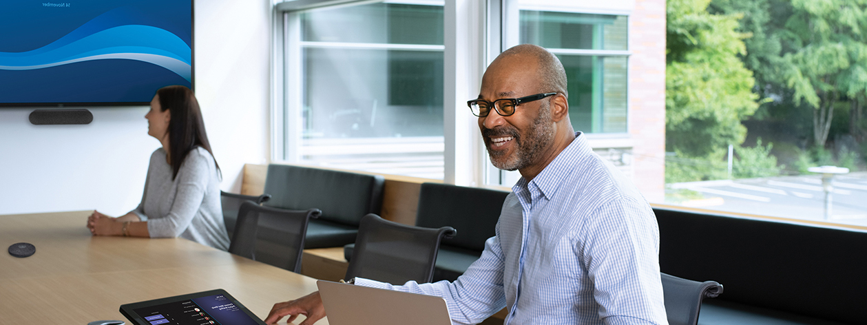 Coworkers sitting in conference room, smiling