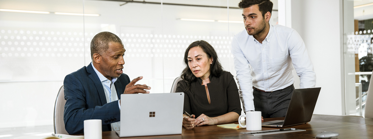 Coworkers sitting at conference table, discussing business