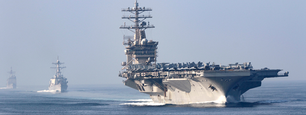 Three U.S. Navy ships in a line at sea